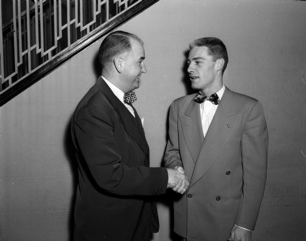 University of Wisconsin boxing coach John J. Walsh congratulates boxer John R. "Dick" Murphy on his selection as captain for the 1951 team.
