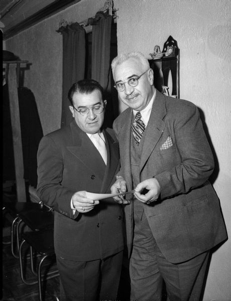 Joseph Bruno presents a check to A.R. Sanna, an honorary member of the Madison chapter of UNICO National, for the Boys Towns of Italy, Inc. in New York City. The funds are used to finance a program for the rehabilitation of Italian boys. The presentation was made at a Madison chapter board meeting dinner at Corona's restaurant, 125 W. Mifflin Street.
The UNICO chapter also honors high school graduates of Italian descent, and scholarship and athletic awards will be made to selected graduates. An expanded scholarship program will invite graduates of other than Italian descent.