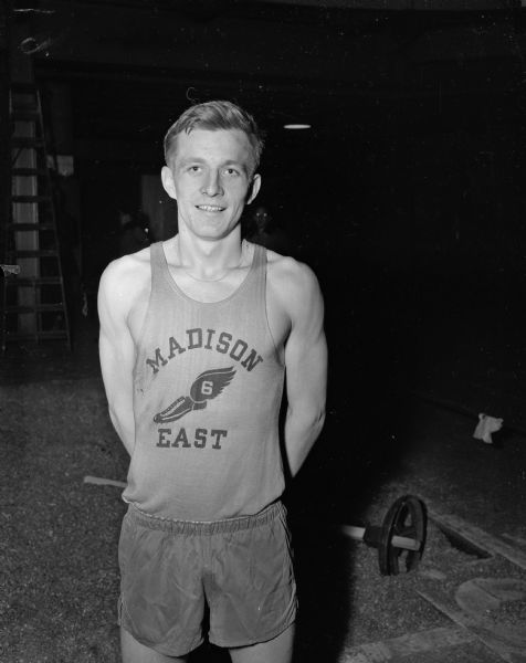 A boy from the Madison East relay team poses for a portrait.  The team won a relay at West High School.
