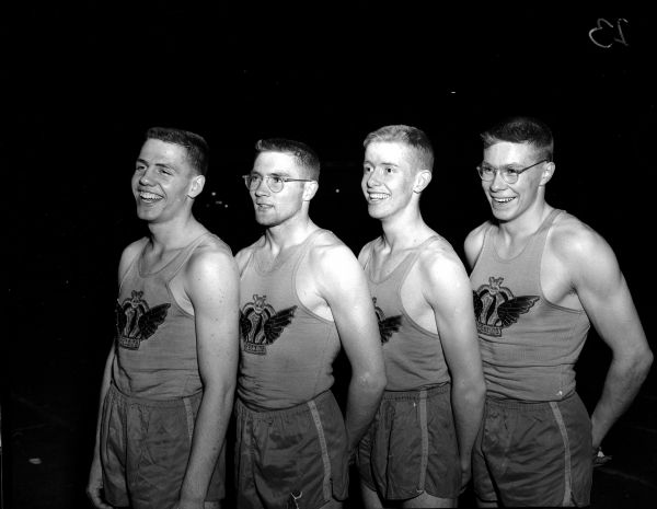 Madison West track team members posing for a group portrait at the West High School relays.  They are, left to right: Ronald Houser, Frank Wendt, Jack Barry, Harlow Roby, and Jack Mansfield. Houser, Barry, Wendt, and Mansfield set the new 880 yard relay record, and Roby, Barry, Wendt and Mansfield set the new one mile relay record.