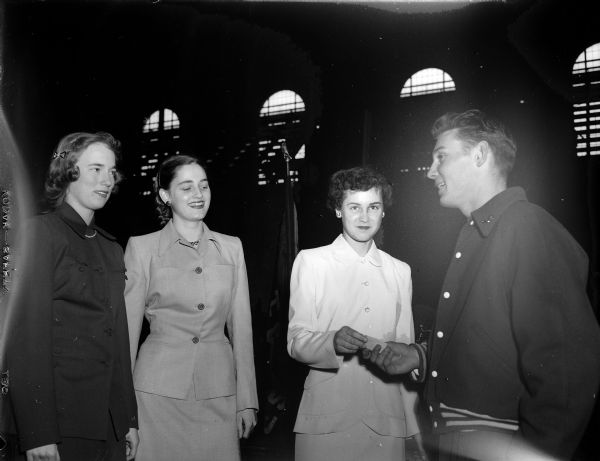 Terry Stracka of Hartford receives one of his Class B first place medals at the West High School Relays. From left to right, the individuals are: Misses Gayle Grelle, Lucia Koltes, Roberta Lee and Stracka. Lee, Queen of the relays, is presenting the award. Misses Koltes and Grelle were escorts for the Court of Honor.