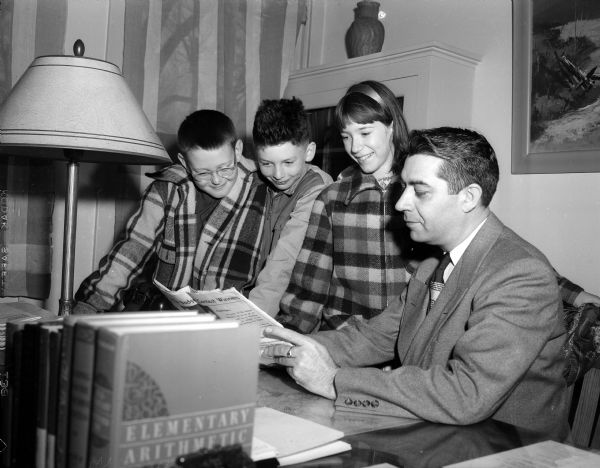 John Wyngaard, Randall school spelling champion, is shown reviewing the word list with the two runners-up and principal H. Ralph Allen. Left to right are: Walter Rhodes, Jr.; champion John; Judy Jeffers; and Allen.