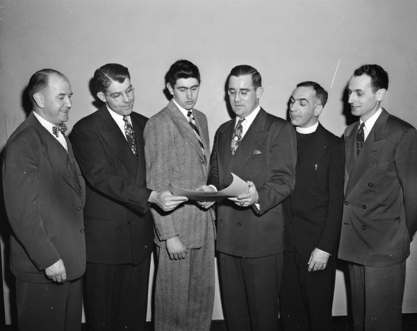 Six principals at the Wisconsin South-Central Notre Dame Alumni Club dinner.  Left to right: Attorney John J. Walsh, U.W. boxing coach and speaker; Maurice Lee, secretary-treasurer; Jack Doyle, accepting the "Man-Of-The-Year" award on behalf of his father Frank Doyle; John Brannan, club president; the Reverend George Maeagher, club chaplain, and Paul Brannan, chairman of the dinner.