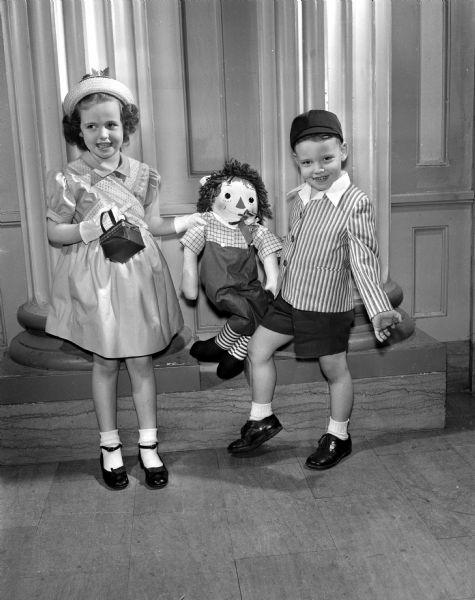 Two of the younger models in the Jaycettes' fashion show pose with a Raggedy Andy doll.  Arthur Gallagher Field, age 3 1/2, and his sister, Betty Ann, 5 1/2, are the children of Mr. and Mrs. Arthur (Ruby) Field of 512 West Washington Avenue.