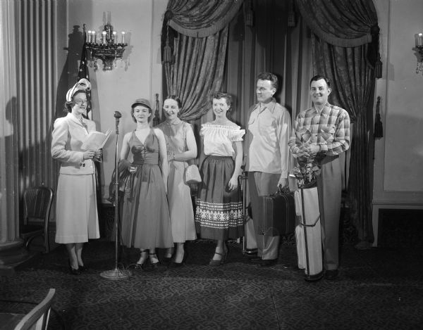 Pictured are Mrs. Gordon (Dolly)  Harmon, at left, who will be the narrator for the Jaycettes' fashion show, and some of the group who will model vacation clothes. Left to right: Mrs. William (Marilyn) Schtjen, 33 North Street; Mrs. Charles (Corrine) Van Sickle, 302 Norris Street; Mrs. Richard (Lucille) Genn, 1933 East Washington Avenue; and Joe Klein, 218 Dixon Street, and Harold Frye, 4345 Felton Place.
