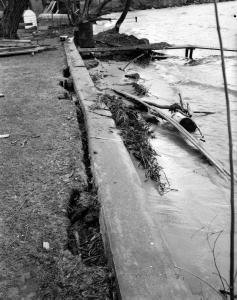 View of damage to the breakwater behind the home of Dr. J.G. Frisch, 1653 Sherman Avenue, caused by high water and waves driven by strong winds.