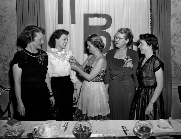 Janet Williams of Kenilworth, Illinois, receives the Pi Beta Phi outstanding member award at the Founders' Day banquet of the University of Wisconsin chapter of the sorority. In the picture are, from left to right: Mrs. T.S. Lively, president of the Madison alumnae group; Miss Williams; Mrs. Edward P. Roemer, chairman of the advisory board; Mrs. J. Frank Kessenich; and Beverly Hollett, LaCrosse, president of the active chapter.