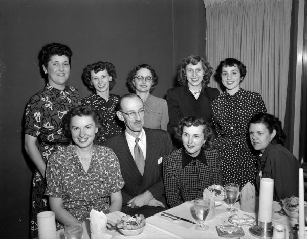 Group portrait of P.A. Cary, 1602 Jefferson Street, retiring classified advertising manager of Madison Newspapers, Inc. and his 
staff at a farewell party. Left to right, front row: Anne Terpstra, P. A. Cary, Maurine Miller, and Ethel Padfield. Back row: Fran Smith, Elinor Dickins, Nancy Higgins, Virginia Schillinger, and Lucille Narowetz.
