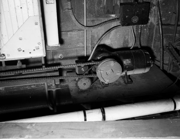 Close-up image of the mechanism of a garage door opener produced by Allen Bradley. The garage doors are installed in the Greyhound Bus Depot and opened onto the alley off the 200 block of West Mifflin Court across from the back of the Gay Building, located on the Capitol Square.