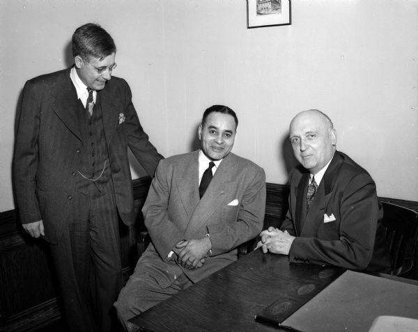Dr. Ralph J. Bunche (center), acting secretary general for the United Nations (UN) department of trusteeship, is shown Monday night with Professor Llewellyn Pfankuchen, University of Wisconsin department of political science (left), and President E.B. Fred, as he opened a series of talks on the Wisconsin campus.