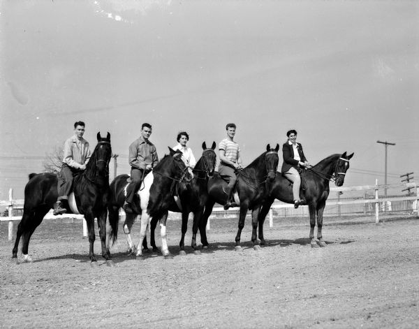 Five University of Wisconsin students sit on horseback as they participate in the Hoofers' horse show. Shown from left to right:  Richard Wilburth, Milwaukee;  Robert Rockweiler, Cazenovia; Barbara Meister, While Plains, New York; Milton Blair, Barron; and Joyce Wexter, Janesville.