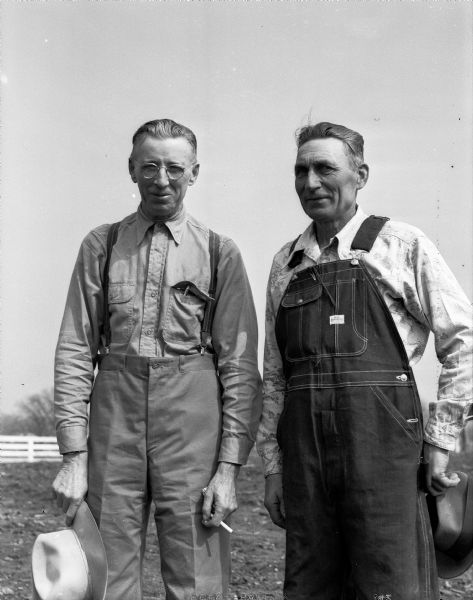 Ed Shey, left, and Peter "Pete" Strand are pictured at their 271-acre hobby "ranch" near Deansville where they are experimenting with raising buffalo, rare long-horn cattle, sheep, and fancy poultry. Mr. Schey also has a pet coyote.