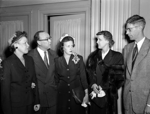 Group portrait of individuals from the Dane County Republican Women's Club. Left to right: Mrs. Warren (Mildred) Ryerson, program chairman for the group; Rep. Lawrence H. Smith (R-Racine), speaker at the luncheon preceding the meeting; Rep. Smith's daughter, Mrs. William E. Walsh, Madison; Mrs. Wayne Hood and Mr. Wayne Hood, state GOP chairman, both from LaCrosse.