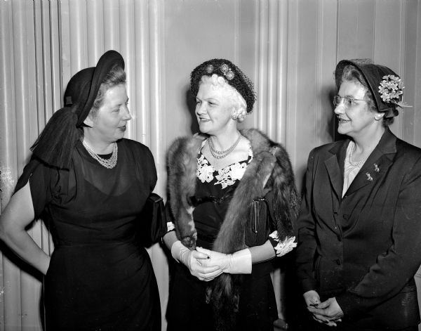 Members of the Dane County Republican Women's Club chat with Mrs. Oscar (Mary) Rennebohm, wife of Wisconsin's governor, (also a member) at their monthly luncheon and meeting. Left to right: Mrs. Foster E. (Gertrude) Blackburn, president of the club; Mrs. Rennebohm; and Mrs. John E. Wise (Glenn) Wise, president of the state Federation of Republican Women's Clubs.