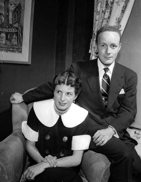Mr. and Mrs. Donald E. Fellows, guests of Mr. and Mrs. Richard P. Grossenbach in Madison, sitingt on an upholstered chair. Mr. Fellows, a graduate of the University of Wisconsin, has been a member of the cast of "South Pacific" on Broadway during the past year. His father, Professor Donald R. Fellows, was formerly of Madison.