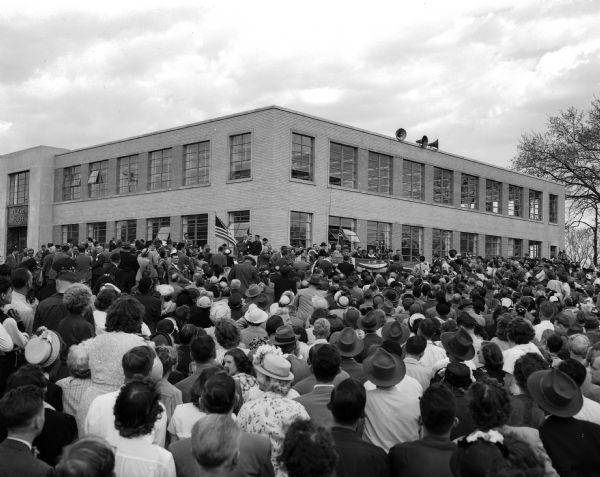 President Harry S. Truman came to Madison for the opening and dedication of the Filene House, located at 1617 Sherman Avenue, and is shown here surrounded by a crowd of 5,000 persons. Filene House will be the headquarters of the Credit Union International Association (CUNA).