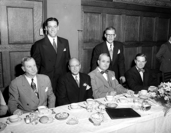 Testimonial dinner for Charles B. Stumpf, elected president of the International Association of Accident and Health Underwriters. Sitting, left to right, are Eugene F. Gregory, Denver, Colorado, chairman of the board; Stumpf; E.H. Mueller, toastmaster; and Stanley Olyniec, Milwaukee, principle speaker. Standing, left to right, are Wesley Jones, Chicago, executive secretary; and Carl Ernst, St. Paul, treasurer.