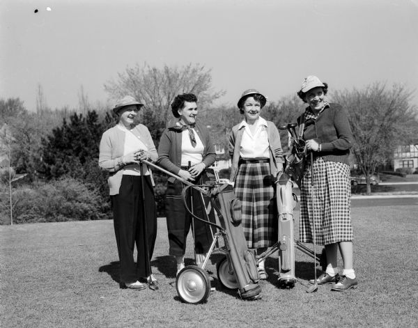 Women golfers wait to tee off at the Nakoma Country Club.  Left to right: Mae McNearney, Adeline Hendrickson, Erminie Linke, Mrs. C.R. Moe.