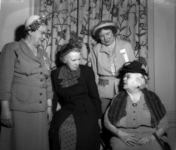 One of the founders of the Madison Catholic Women's Club and of the state council, Mrs. E.T. Baille (right) is shown chatting with Mrs. N.J. Luke Mergen, Mrs. J.E. Lynch and Mrs. T.J. Pattison at the 35th annual Wisconsin Council of Catholic Women meeting.