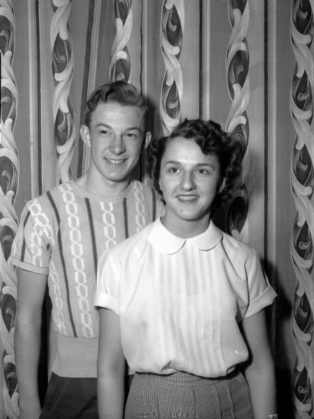 Don Noel and Jeannine Radke, king and queen of Central High School's senior dance, pose against a wallpapered wall.
