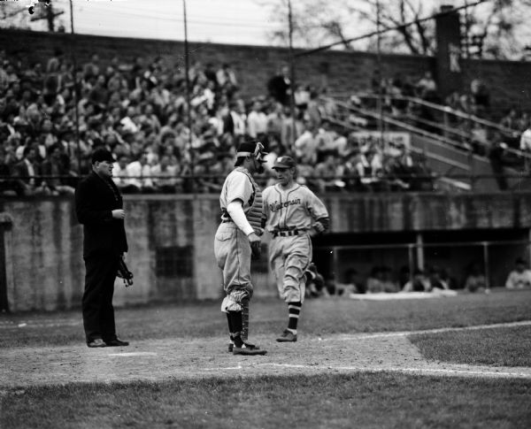 One of three action images of base running and fielding during a baseball game between Wisconsin and Michigan.