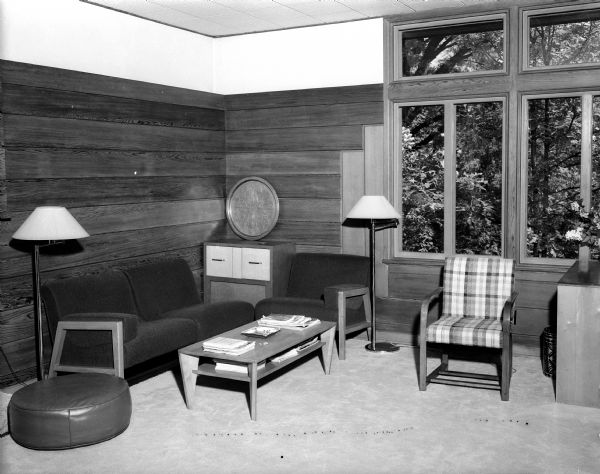 Interior view of the Porter Butts house at 2900 Hunter Hill, Shorewood Hills, one of the first "modern" houses in the Madison area, built in 1937. The seating area in the sunroom/study is featured, showing the horizontal redwood paneling on the walls and the windows with new-style vertical blinds to control the sun's rays.