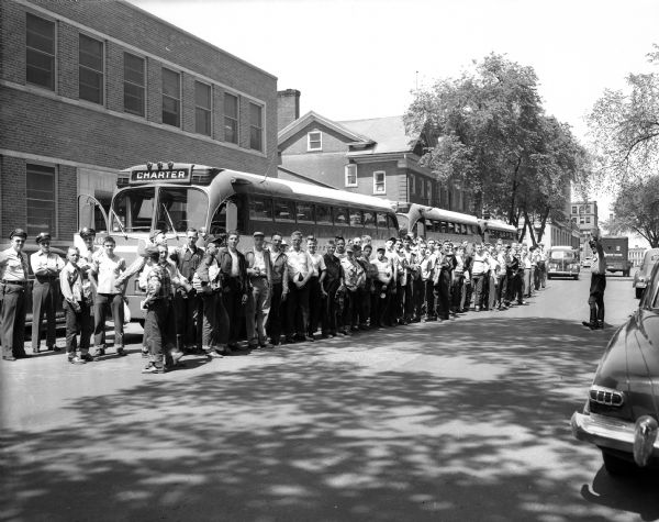 101 Madison Newspapers, Inc. carrier boys from Madison and southwestern Wisconsin stand by three charter buses before the start of their trip to the Memorial Day Indianapolis Speedway races.  The boys won the trip by selling 25 or more newspaper or magazine subscriptions in a circulation contest.