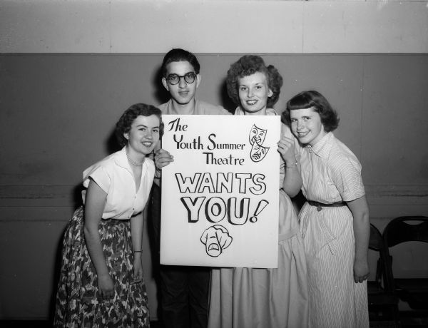 Members of the Madison Youth Theater board of governors are shown holding a sign advertising their summer program. Pictured left to right are Charlene Schaefer, Arlen Rosenbloom, Nancy Waters, and Peggy O'Neill.