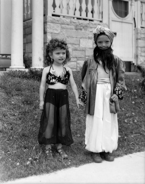 Vernie Swenson, 4 1/2, on the left, and her brother, Juddy, are shown in the exotic costumes they wore at the Memorial Day parade and celebration sponsored by the University of Wisconsin faculty living in University Houses at Eagle Heights. Vernie and Juddy are the children of Mr. and Mrs. George Swenson, Jr.