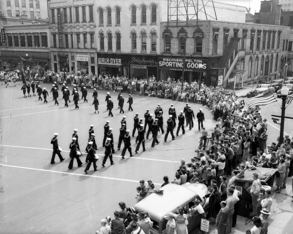 Elevated view of Madison's Naval ROTC members rounding the corner at South Carroll and West Main Street during the Memorial Day parade on the Capitol Square.