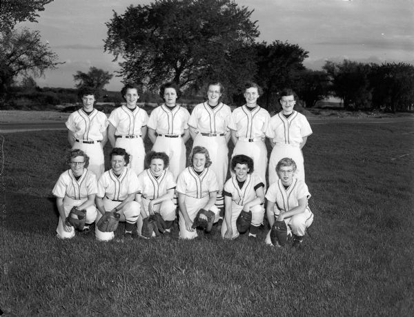 Group portrait of the Penn Electric girls softball team of Madison who will play in the West Allis Major League. Team members are, front row left to right: Georgia Meiller, Elna Lombard, Corky Kubicek, Betty Napstad, Eleanor Davis, and Phil Winger. In the back row, left to right: are Helen Payne, Carol Washa, Ramona Kivlin, Doris Hanson Lee Feldpausch, and Helen Medenwald.