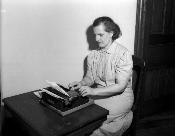 World War II war relief services.  Woman typing.