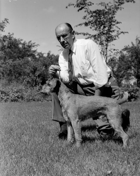 Forrest Gillett, Chair of the Grounds Committee for Badger Kennel Club Dog Show, is shown with his Irish Setter, Mr. Chips of the Terrace.