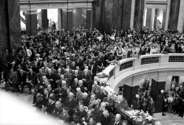 Elevated view of the crowd in the Wisconsin State Capitol rotunda during the funerals for University of Wisconsin president Glenn Frank and his son Glenn, Jr. The father and son died September 15, 1940 in an automobile accident south of Green Bay while campaigning for the Republican nomination for the United States Senate.
