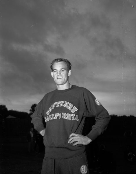 Portrait of Dick Attlesey, of the University of Southern California, who captured the 120-yard high hurdles in 13.8 seconds, setting a meet and Camp Randall stadium record, at the Big Ten-Pacific Coast intercollegiate track meet.