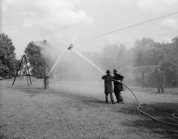 Firemen add a little horseplay to their water fight competition.