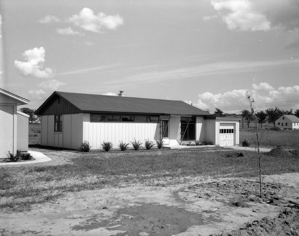 Advertising photograph for a housing contractor company called Space Inc. Pictured is a house at 3903 Nicholas Road built by Space Inc. contractor Ivan D. Gregory.