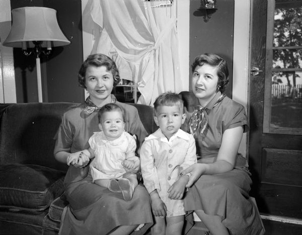 Mrs. John H. Eggleston (left) of Rockford, Illinois and her 8-month-old daughter Sheryl sit with the former's sister-in-law, Mrs. William B. (Catherine) Gedko, and her 3-year-old son William ("Tad") at the Gedko family home.