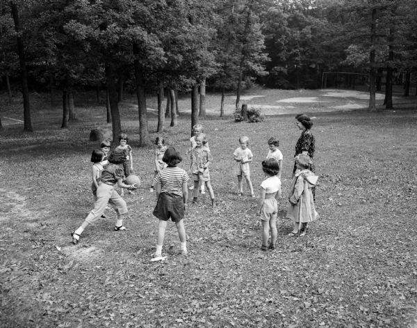 Children play a game of touchball at the Nakoma school playground, one of the many activities offered at the city's playgrounds by the board of education recreational division.