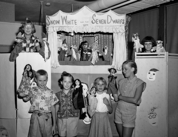 Children participate in a puppet show as part of the "open house" of the Shorewood Hills summer children's recreational program.