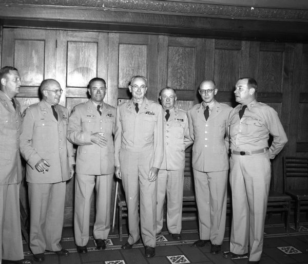 Major General John F. "Mugs" Mullen is honored at a dinner for his retirement from the Wisconsin 32nd Division of the Wisconsin National Guard. Shown in the group portrait are, left to right: Colonel Marc J. Musser, Colonel George C. Sherman, Colonel Archibald M. Mixon, Mullen, Colonel Harry C. Williams, Colonel Dee Ingold, and Lieutenant Colonel John W. Roach.