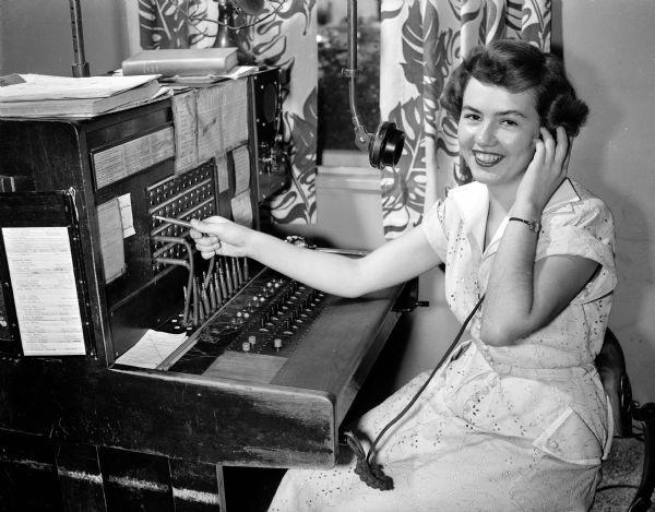 Charlene Schaefer, East High School 1950 graduate, is shown operating the telephone switch board at Lake View Sanatorium.