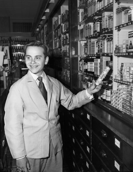Sherwyn Woods, 1950 Wisconsin High School graduate, is shown spending his third consecutive summer as an employee of the Rennebohm Drug Company.
