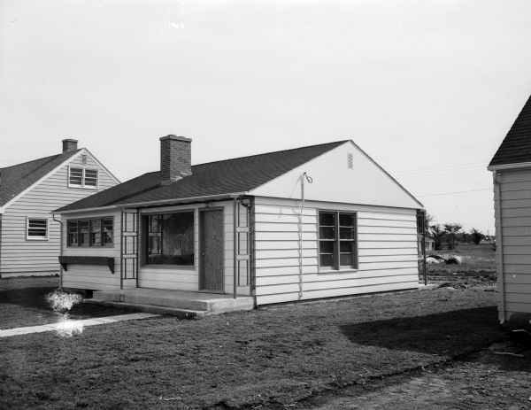 View of a model home constructed at 205 Harding Street by A.A. Elkind & Company, builders and developers. The image appeared in an advertisement for the company, whose office was located at 1940 Winnebago Street.