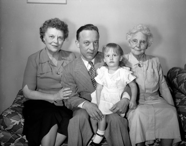 Family portrait of Harold E. McClelland, his wife Beulah McClelland, her mother Mary Day, and a young girl.  Harold McClelland was state editor of the Wisconsin State Journal.
