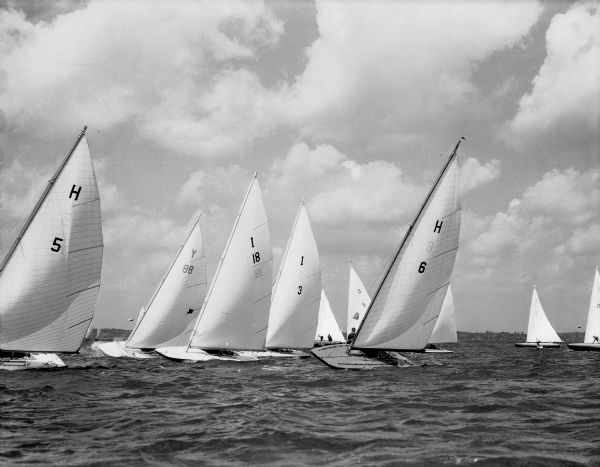 Class C sailboats heel to port in a stiff breeze during one of the races of the 49th Annual Regatta of the Inland Lakes Yachting Association.