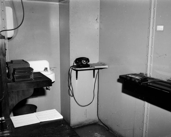 A telephone in the cell block at the Madison police headquarters, adjacent to the fingerprinting counters, explicitly for use by arrested persons. The picture was in the newspaper because of a controversy over the use of a telephone by a state assemblyman who was arrested for "tipsy driving."