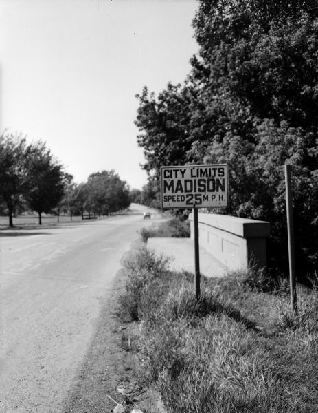 The Madison city limits sign on Olin Avenue at Wingra Creek displays the start of the 25 miles per hour speed limit leaving the rural section of road.