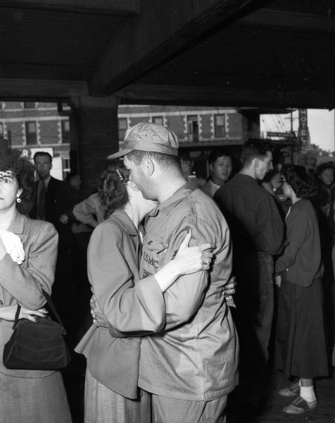 Madison Marine Reserve staff Sgt. Frank J. Kasinski embraces his wife before boarding the train taking the reserve unit for active duty in Korea.