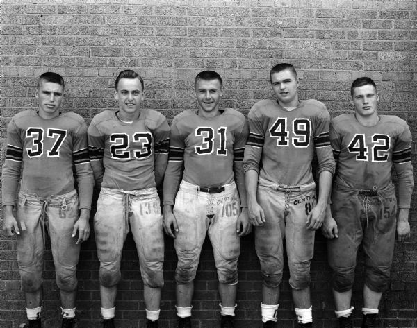 Group portrait of five unidentified Central High School football players in uniform.